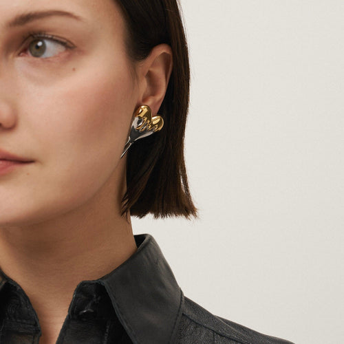 Load image 1 in gallery view. Girl Wearing Gold Plated Heart Stud Earrings. Shop at Mithra and Co.