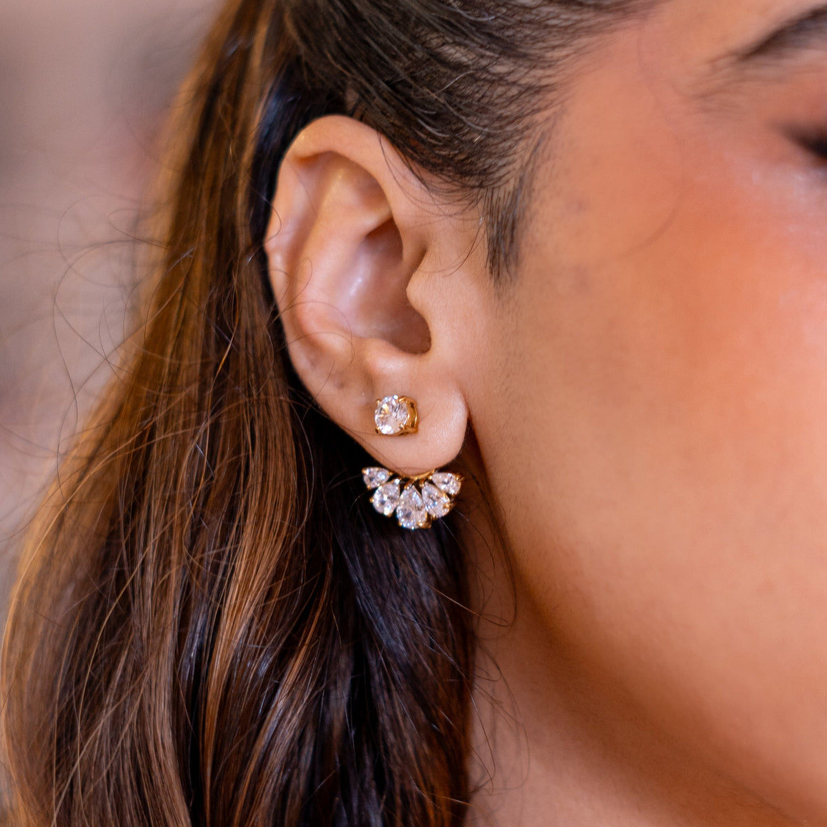 Sham'a ear jacket close up on the ear, the stone fan curving beneath the lobe, hair swept back
