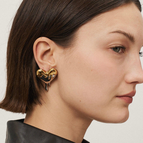 Load image 1 in gallery view. Girl Wearing Gold Plated Heart Stud Earrings. Shop Online at Mithra and Co.