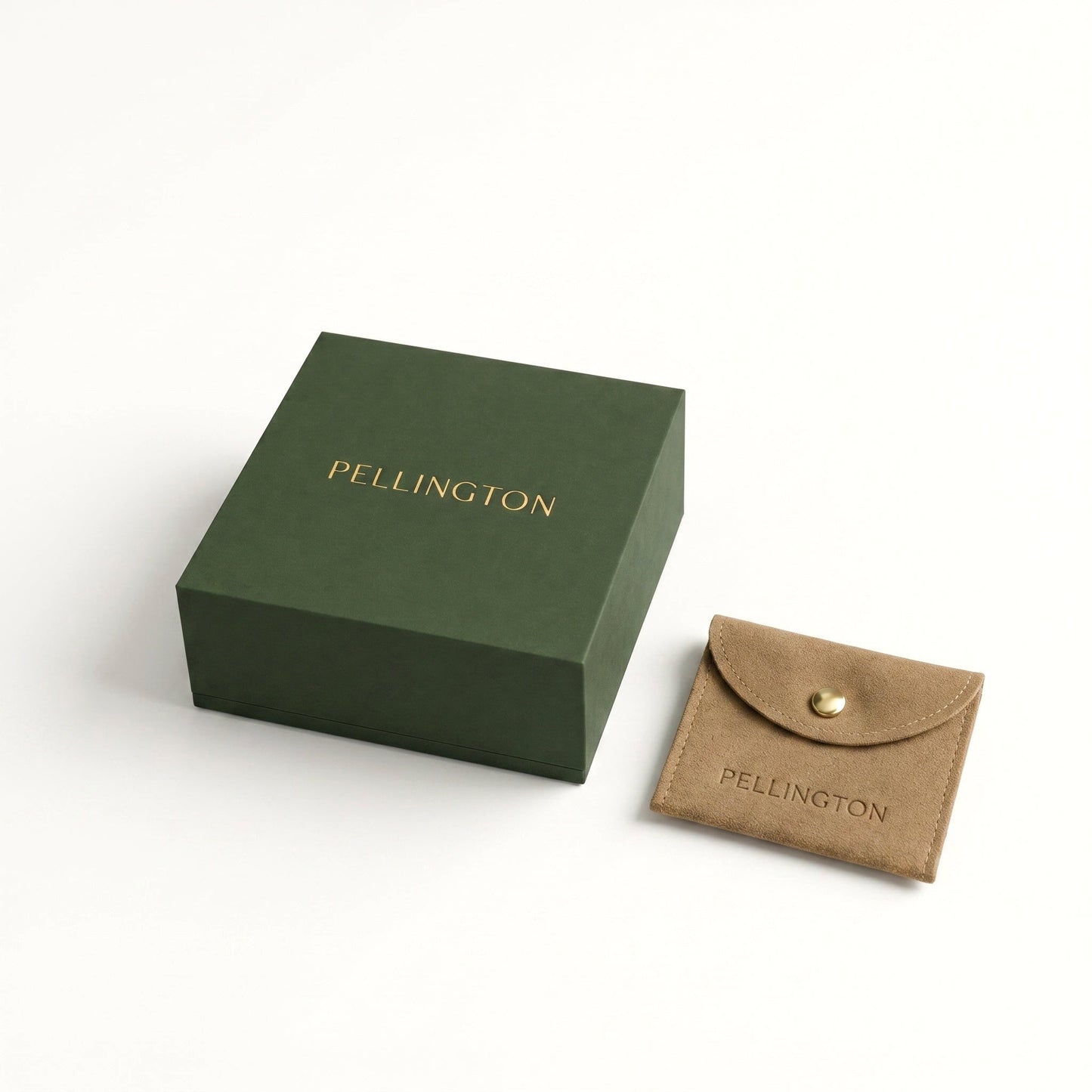 Pellington gift box in deep green with gold foil lettering, next to a taupe suede pouch with a gold press stud